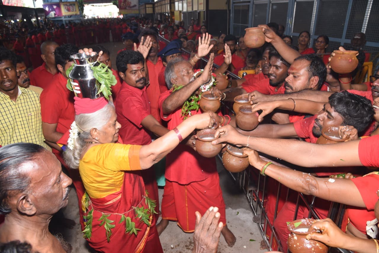 Devotees serving and receiving blessings
